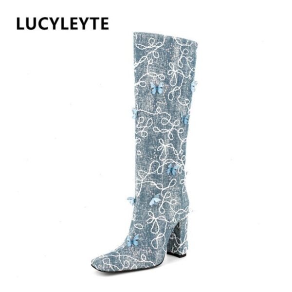 stylish black high boots with butterfly embellishment